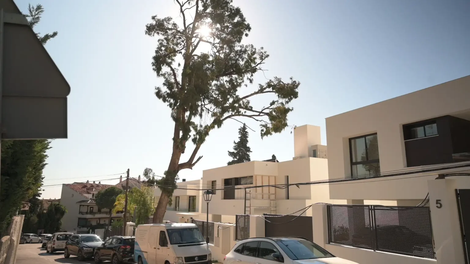 We offer townhouse inspections in Marbella. The image shows a collection of low white houses under a clear sky.